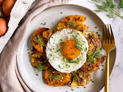 Crispy smashed potatoes recipe using hot honey and topped with a fried egg | peteandgerrys.com
